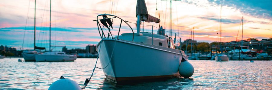 a boat tied to a buoy in a harbor